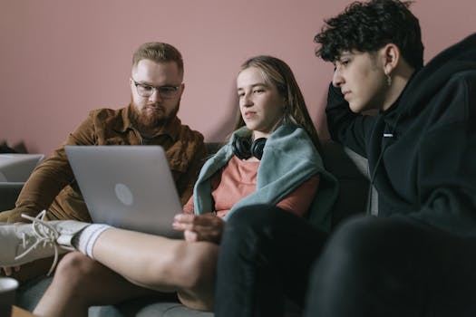 Build AI Receptionist SaaS with Lovable & OpenAI 4 Young diverse team collaborates on a project using a laptop in an office setting even with no experience creating high value web app.